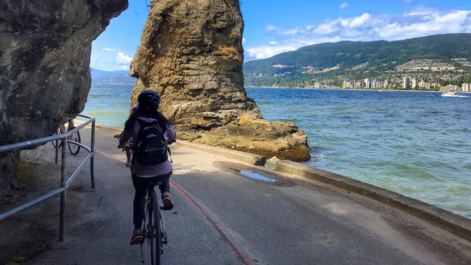 Cyclist on Vancouver seawall at dusk